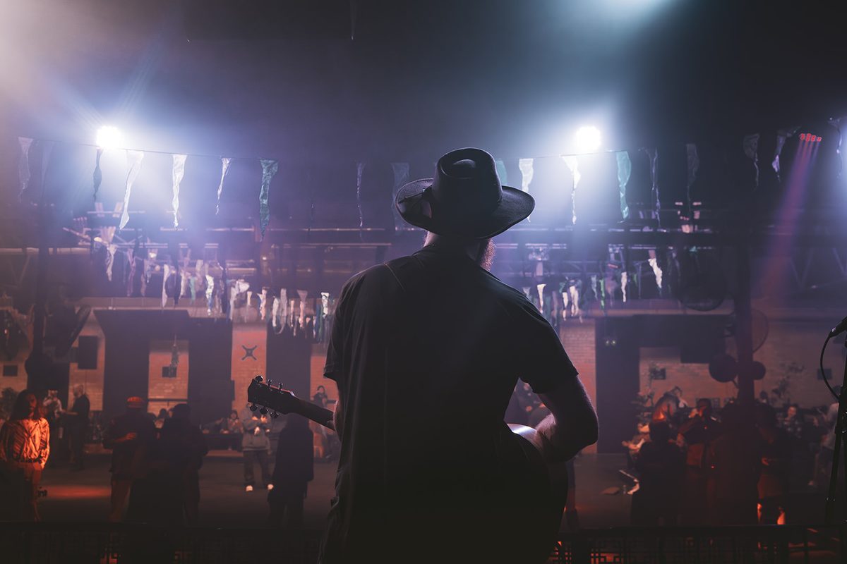 Brent Hayhurst on stage, backlit